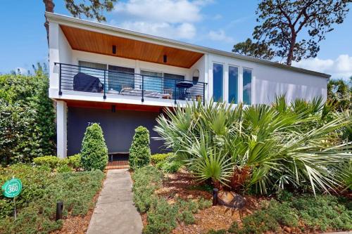 a house with a balcony and some plants at 10 Pines - Sarasota Bay in Sarasota