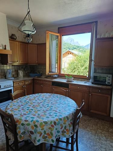 a kitchen with a table with a table cloth on it at Appartement Marthod in Marthod