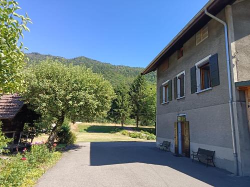 a building with a tree in front of it at Appartement Marthod in Marthod