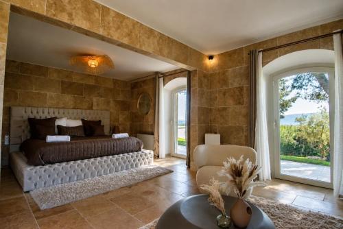 a bedroom with a bed and a large window at La Villa Mirau in Cavaillon