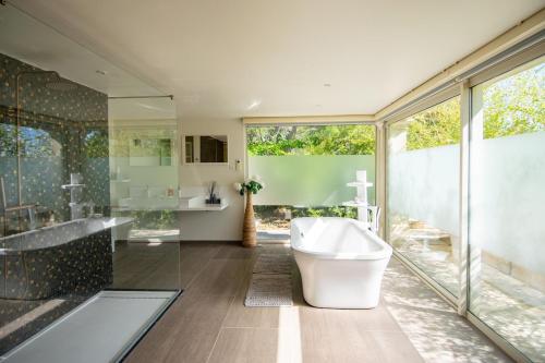 a bathroom with a tub and a sink at La Villa Mirau in Cavaillon