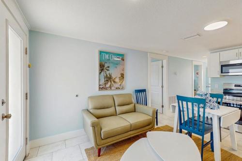 a living room with a couch and a table at Playa Casanas South in Holmes Beach