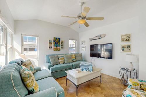 a living room with a couch and a tv at Sea's The Day in Anna Maria