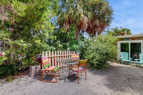 a table and chairs sitting in front of a house at 21 Palms on Anna Maria in Anna Maria