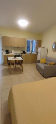 a living room with a couch and a table at Nicol's apartment in Ermoupoli