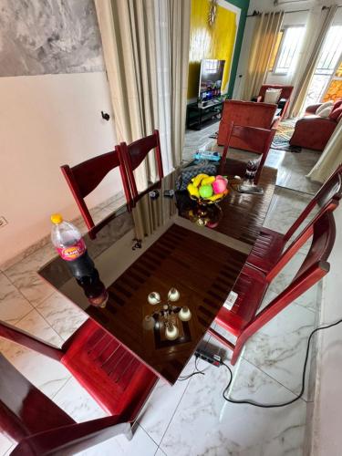 a dining room table and chairs in a living room at Royal guest home in Bonamoussadi