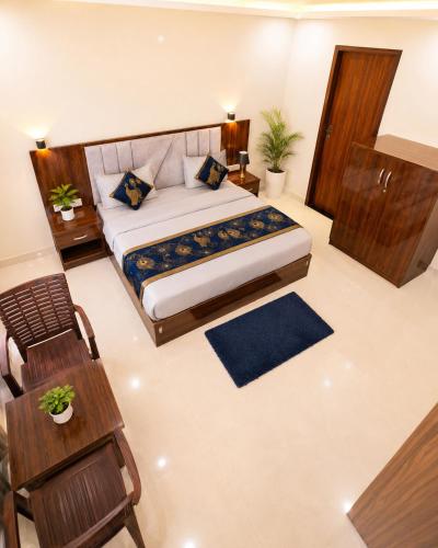 a bedroom with a large bed in a room at Premium Radhe Dham Hotel & Restaurant - Fully AC - Only 5 Min Drive to Prem Mandir, Newly Build in Vrindāvan
