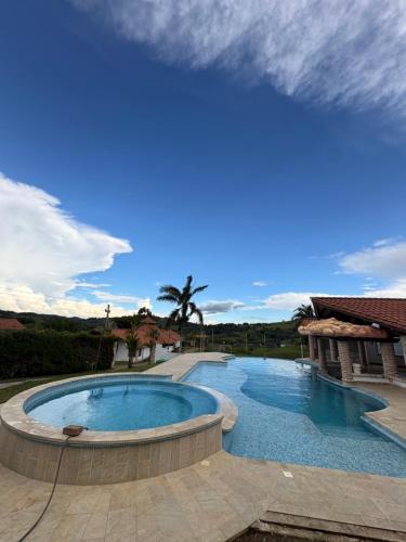 a large swimming pool in the middle of a yard at Finca La Yeye in Puentetierra