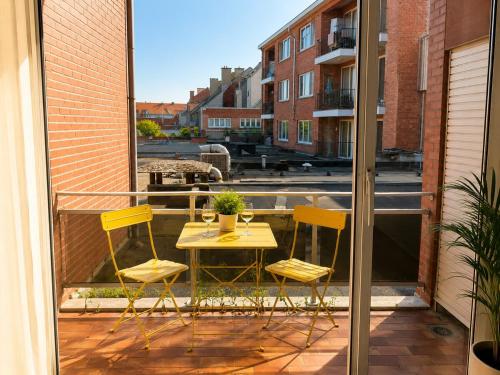 a patio with a table and two chairs on a balcony at Modern 2 BR apartment in Centre in Sint-Niklaas