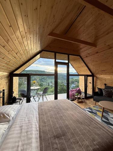 a bedroom with a bed and a large window at Debed View in Debed