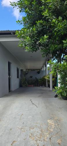 an empty courtyard of a house with a tree at Mecejana Home in Boa Vista