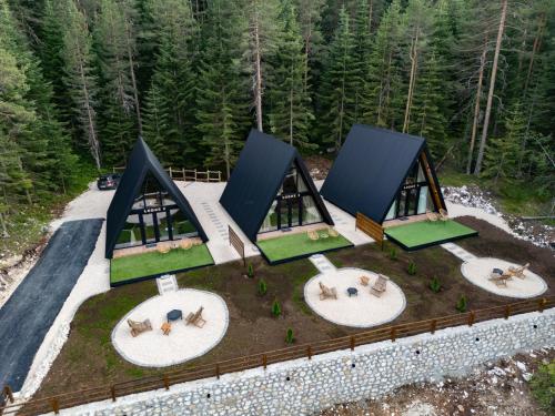 an overhead view of a house with four circles in the ground at Durmitor forest lodge in Žabljak