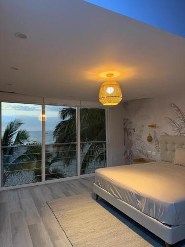 a bedroom with a bed and a view of the ocean at Casa Marena Punta Sal in La Bocana