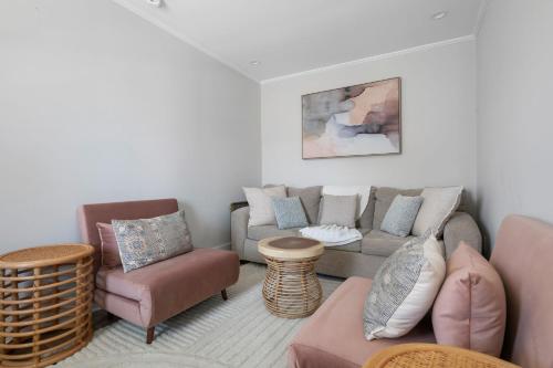 a living room with a couch and chairs at Downtown CHS King Beds Convert to Singles in Charleston