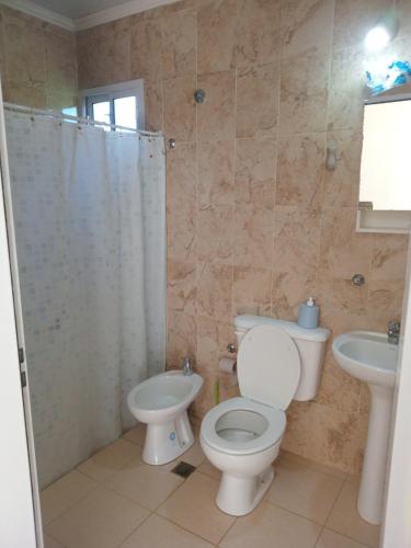 a bathroom with a toilet and a sink at Coastal Apartment in Monte Caseros