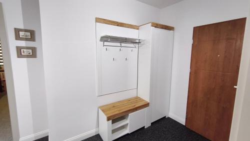 a room with a white closet with a wooden door at Przy Głównej in Zamość