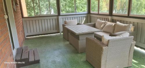 a screened in porch with two chairs and a table at Lägenhet nära hallstaberg & centrum in Sollefteå
