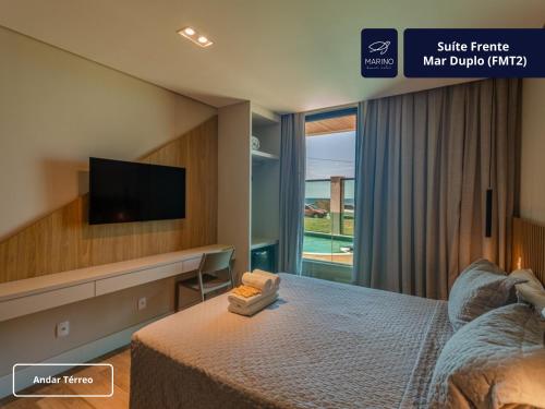 a hotel room with a bed and a tv at Marino Beach Hotel in Cabo Frio