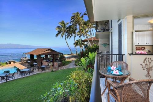 a balcony of a house with a view of the ocean at Noelani 113 in Kahana