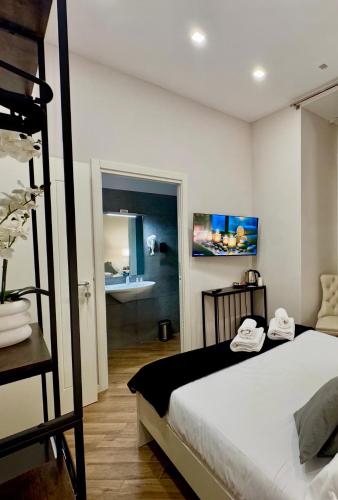 a bedroom with a bunk bed and a bathroom at MILUAR Relais - Piazza Fuga in Naples