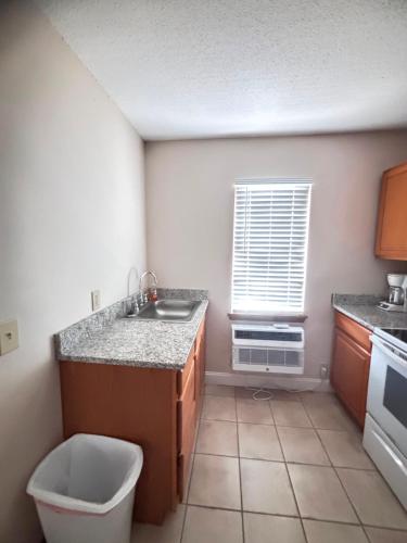 a small kitchen with a sink and a window at Seven Seas in Kure Beach