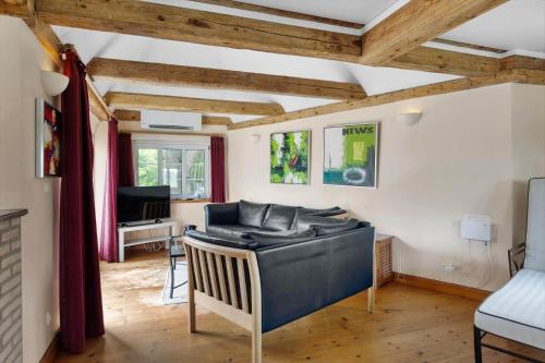 a living room with a bed and a desk at SB137-Grasten-Dalsgardvej-12 in Gråsten