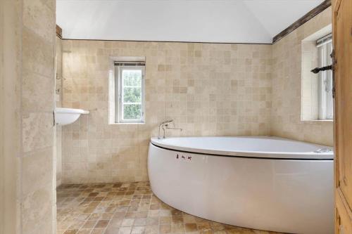 a white tub in a bathroom with a window at SB137-Grasten-Dalsgardvej-12 in Gråsten