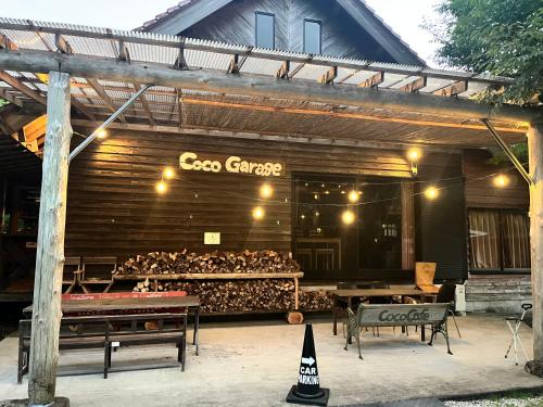 a building with a store with a lot of chickens at Guesthouse Coco Garage in Kirishima
