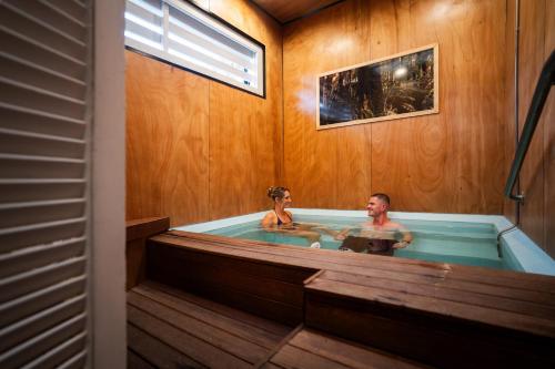 a man and a woman in a bath tub at Aura Accommodation in Rotorua
