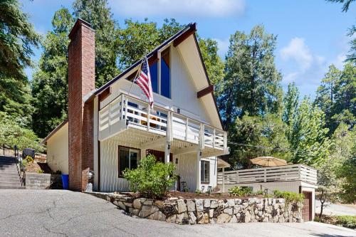 a house with an american flag on top of it at The Fairway Chalet in Lake Arrowhead