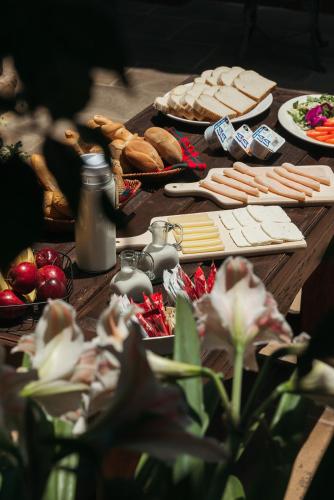 a wooden table topped with lots of bread and food at Mansion de los Sueños in Pátzcuaro