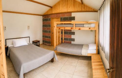 a bedroom with two bunk beds in a room at Mirador Mindo in Mindo