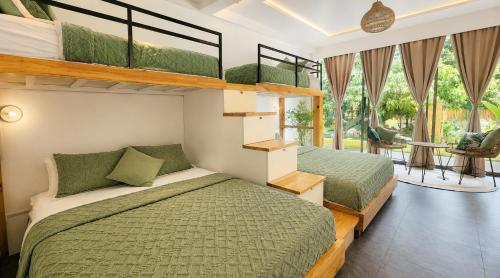 a bedroom with two bunk beds and a balcony at Villa Silana in Moalboal