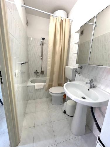 a white bathroom with a sink and a toilet at Casa Nica in Naro