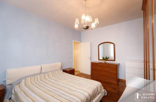 a bedroom with a bed and a dresser and a mirror at Residenza San Nicolò in Treviso