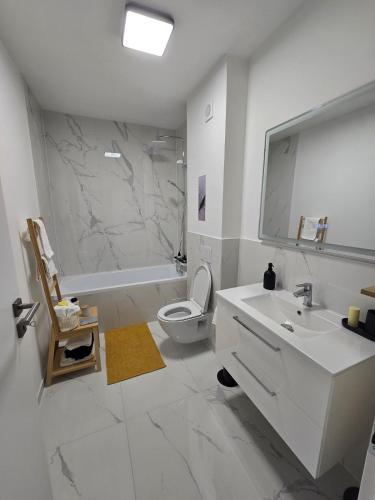 a white bathroom with a sink and a toilet at Sunny Premium in Cristian