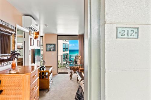 a living room with a view of the ocean at Noelani 212 in Kahana