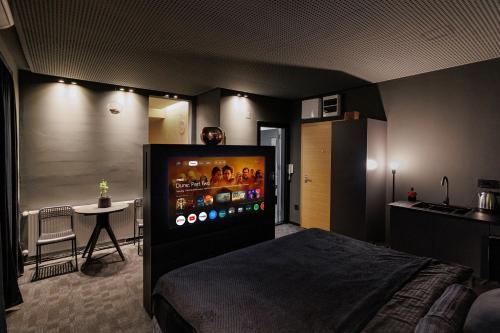 a bedroom with a bed and a table in a room at Hedonist SPA in Jagodina
