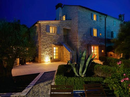 a stone house with a cactus in front of it at Heritage Villa Cranzetti in Svetvinčenat
