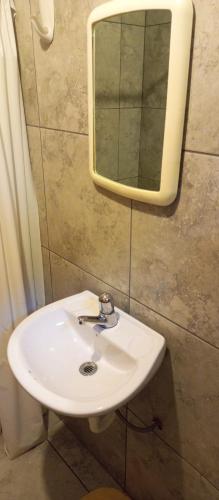a bathroom with a white sink and a mirror at Mirador Mindo in Mindo