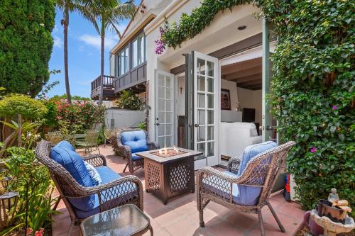a patio with wicker chairs and a table at Garden Escape in Santa Barbara