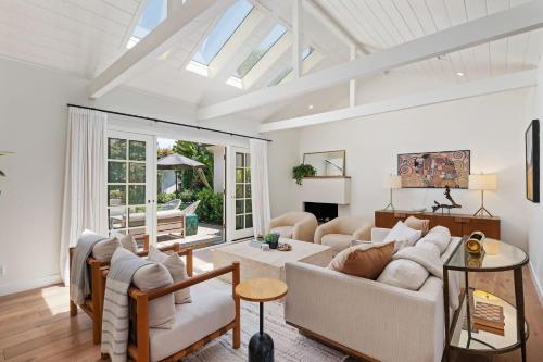 a living room with white furniture and a skylight at Hedgerow Jewel Box in Santa Barbara