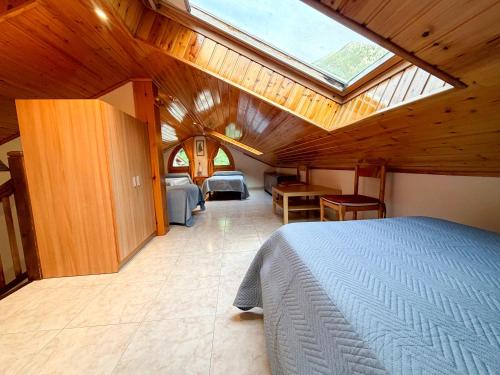 a bedroom with a bed and a skylight at Cases Artigues in Os de Civís
