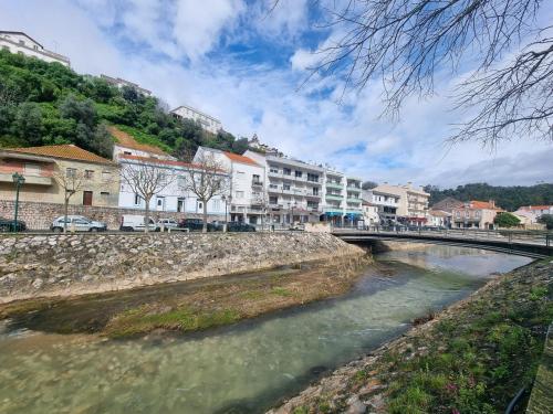 a bridge over a river in a town at Discoveries House Alenquer in Alenquer