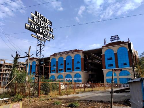 a large building with a sign in front of it at Hotel Rudrax in Waghoria