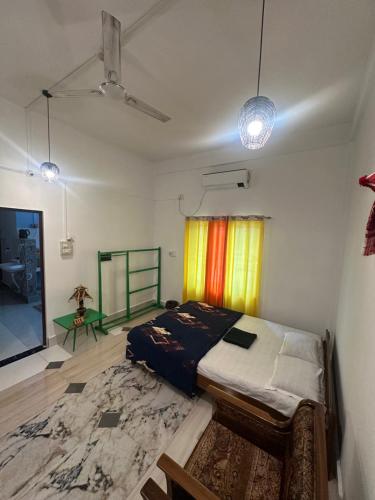 a bedroom with a bed in a room with a rug at NDM Homestay 2BHK in Sibsāgar