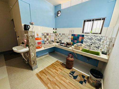 a bathroom with a sink and a toilet in a room at NDM Homestay 2BHK in Sibsāgar