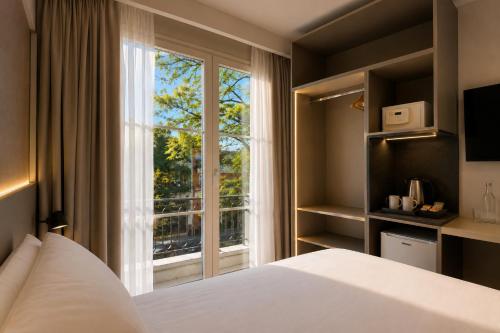 a bedroom with a bed and a large window at Purobaires Hotel Boutique in Buenos Aires