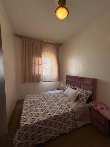 a bedroom with a large bed and a window at maison souk agadir in Agadir