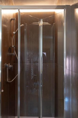 a shower with a glass door in a bathroom at Chioggia Apartment in Chioggia